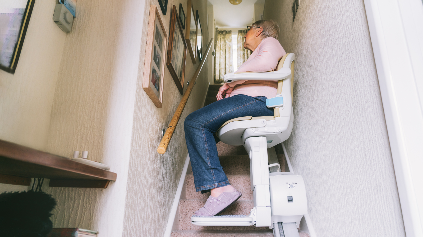 Woman on a stairlift installed in home in Long Island, NY